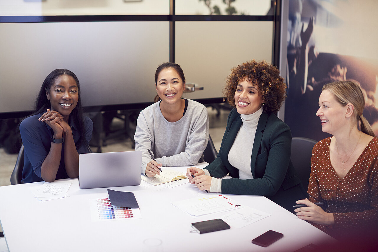 Group Of Businesswomen Collaborating In Creative Meeting Around