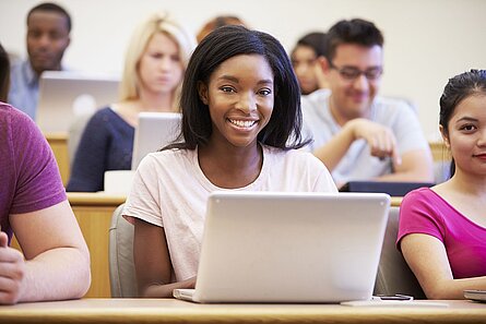 Female University Student Using Laptop In Lecture